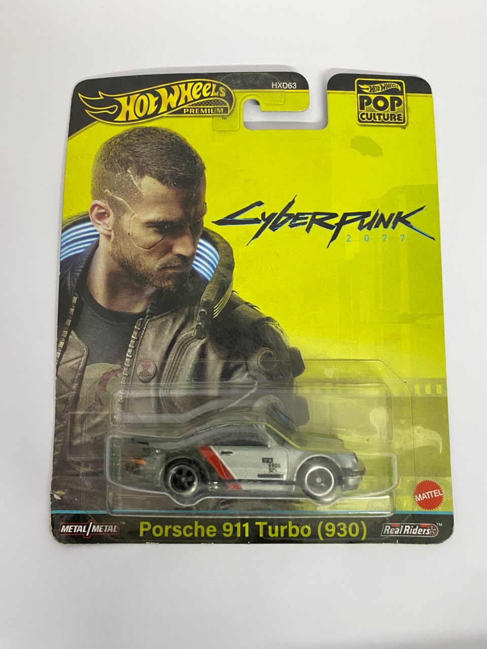 Hot Wheels Premium Pop Culture: Cyberpunk 2077 Porsche 911 Turbo (930) – 1:64 Scale Diecast Car (Real Riders)